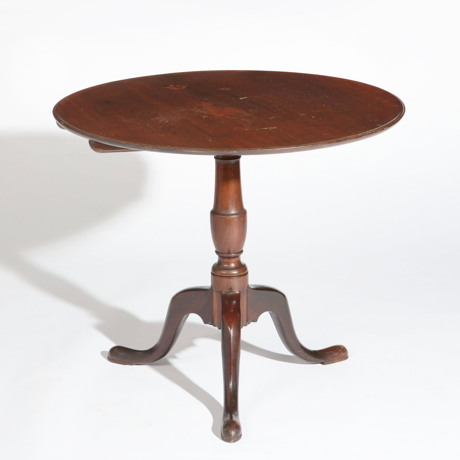 A George III mahogany tilt top breakfast table: A George III mahogany tilt top breakfast table third quarter 18th century height 28 1/4in (71.5cm); diameter 32 1/2Provenance: Property from a Private Collector, Pasadena, California.