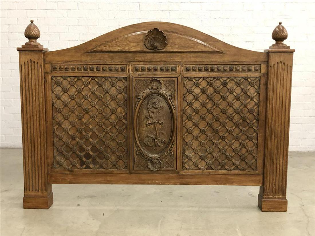 A Louis XVI style oak headboard: A Louis XVI style carved oak headboard incorporating antique and later elements The center with carved initial L. height 60 1/2in (154cm); width 84 1/2in (214.5cm); depth 6in (15cm)