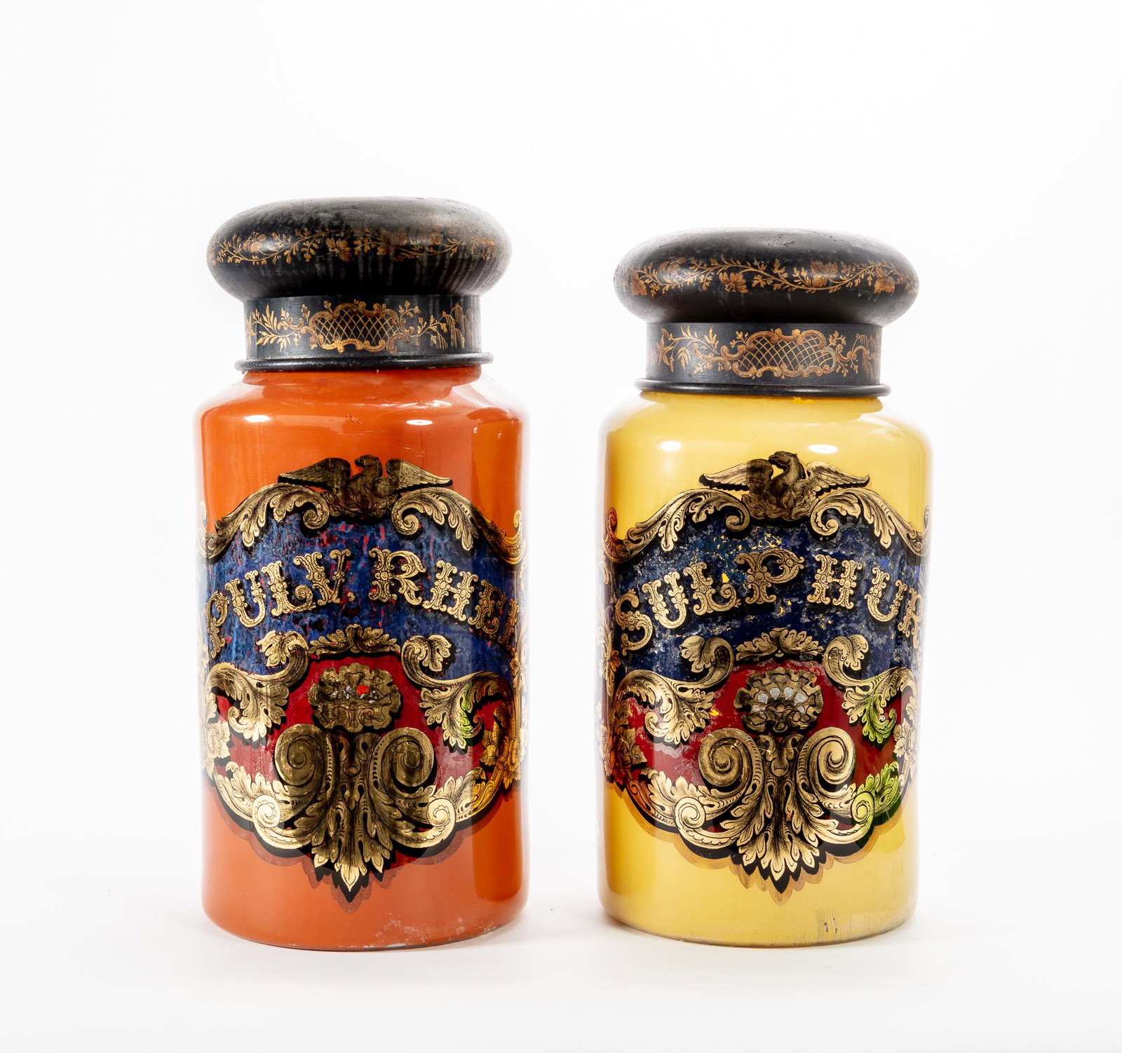 Pair English painted glass apothecary jars: An imposing pair of English reverse painted glass apothecary display jars with tole lids second half 19th century One inscribed SULPHUR and the other PULV. RHEI. height23 1/4in (59.5cm); diameter 11 1