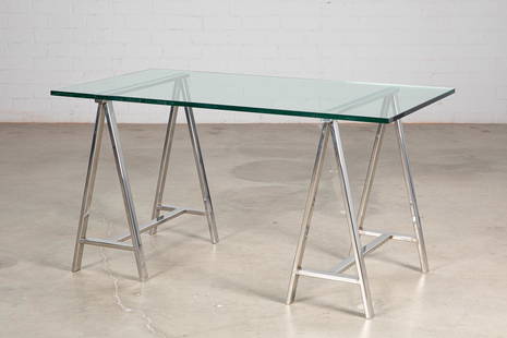 A Marcello Mioni chrome and plate glass desk: A vintage chrome and plate glass saw horse form desk by Marcello Mioni20th centuryheight 29 1/4in (74cm); width 55in (139.5cm); depth 29 1/2in (75cm) Provenance:Property of a Beverly Hills Col