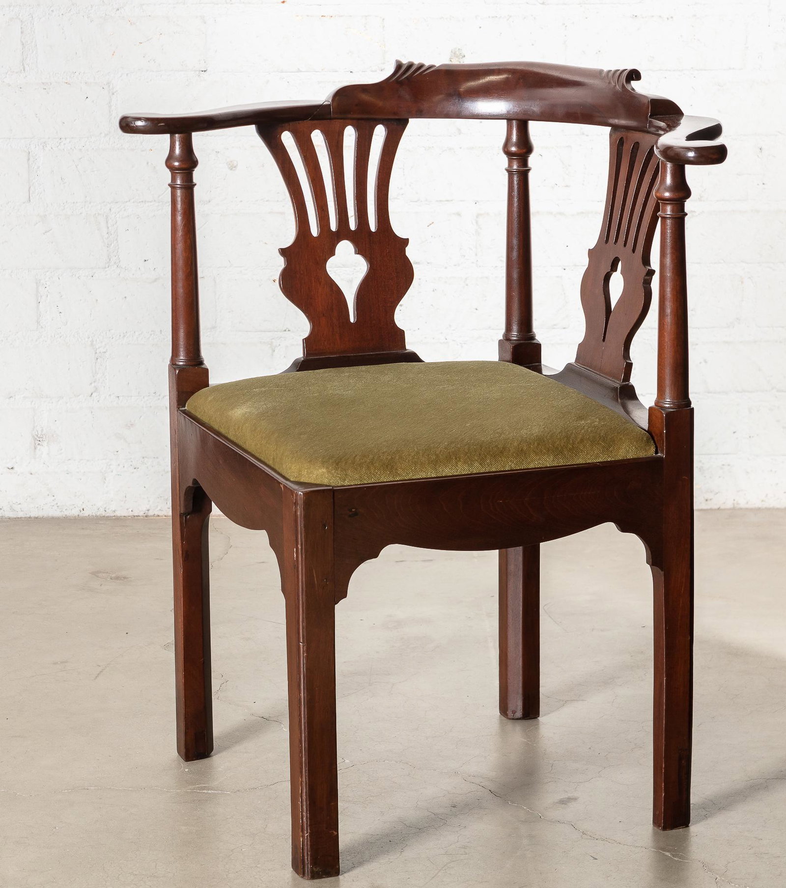 George III style carved mahogany corner armchair: A George III style carved mahogany corner armchair 19th century height 32in (81.5cm); width 28 1/2in (72.5cm); depth of seat 23in (58.5cm)