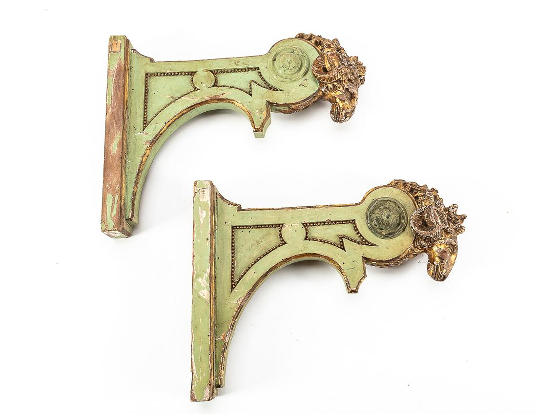 A pair of Italian Neoclassical ram s head brackets: A pair of Italian Neoclassical green painted and parcel gilt ram's head brackets early 19th century height 12 1/2in (32cm); width 3in (7.5cm); depth 16in (40.5cm) Provenance: Property from the Estate