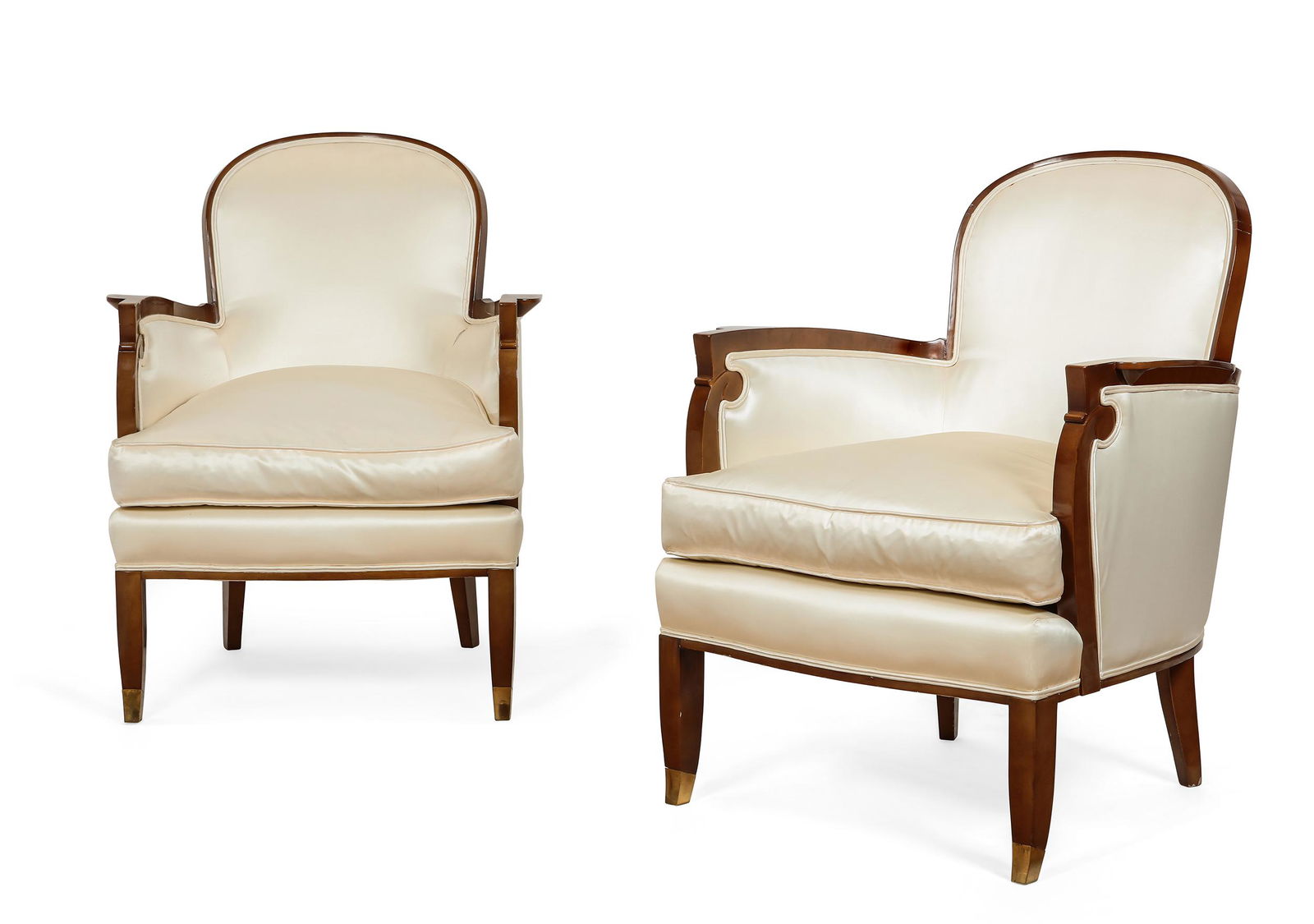 A pair of mahogany bergeres after Jules Leleu: A pair of Art Moderne ivory silk upholstered mahogany bergeres after the model by Jules Leleu for the SS Ile de France second quarter 20th century height 32 1/2in (82.5cm); width 23in (58.5cm); depth
