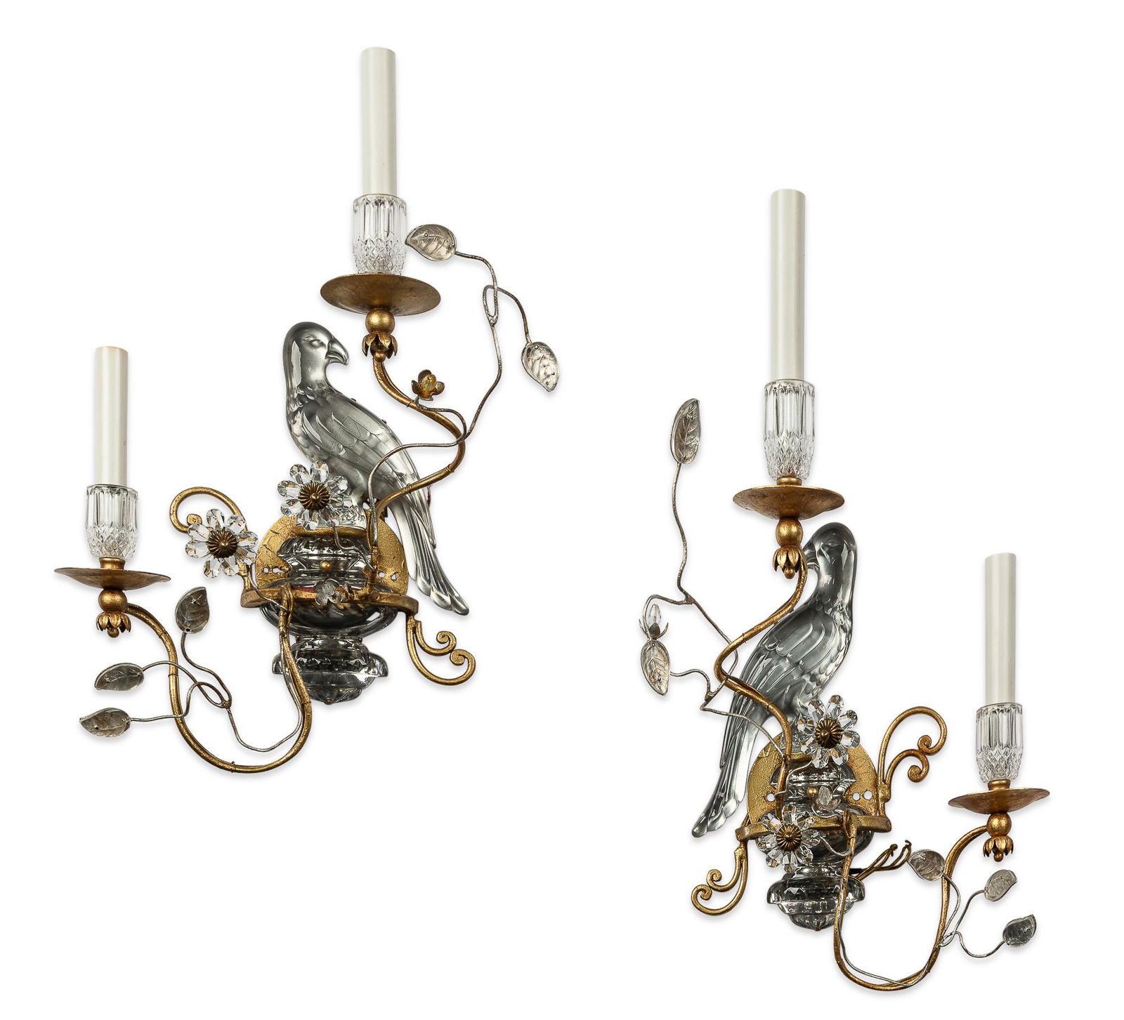 A pair of parrot form wall lights after Bagues: A pair of gilt metal and pressed glass parrot form twin branch wall lights in the manner of Maison Bagues mid 20th century height 20 1/2in (52cm); width 14in (35.5cm); depth 6in (15.5cm) Provenance: P