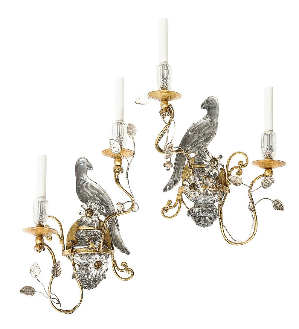 A pair of parrot form wall lights after Bagues: A pair of gilt metal and pressed glass parrot form twin branch wall lights in the manner of Maison Bagues mid 20th century height 20 1/2in (52cm); width 14in (35.5cm); depth 6in (15.5cm) Provenance: P