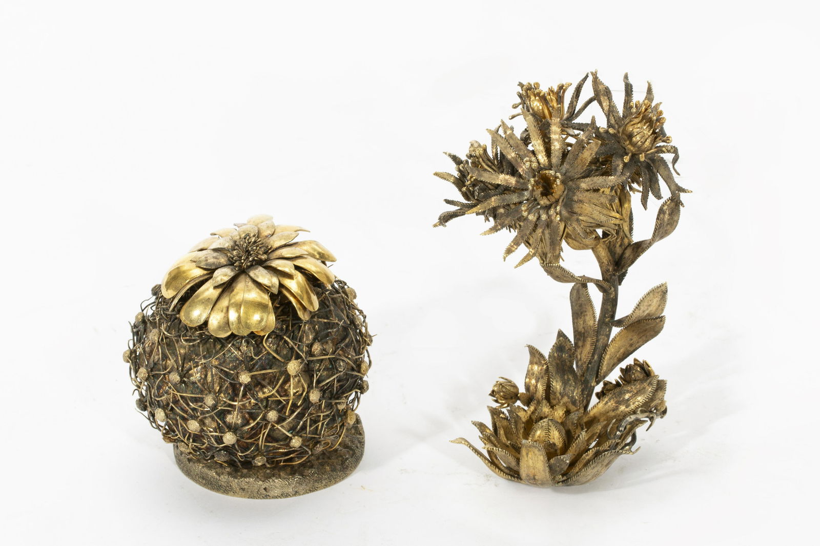 Tiffany & Co.: two silver ornaments De Velarda: Tiffany & Co.: two Mexican sterling silver gilt botanical table ornamentsdesigned by Janna Thomas De VelardaOne in the form of a flowering barrel cactus and another variety.height of taller 5 1/2in (1