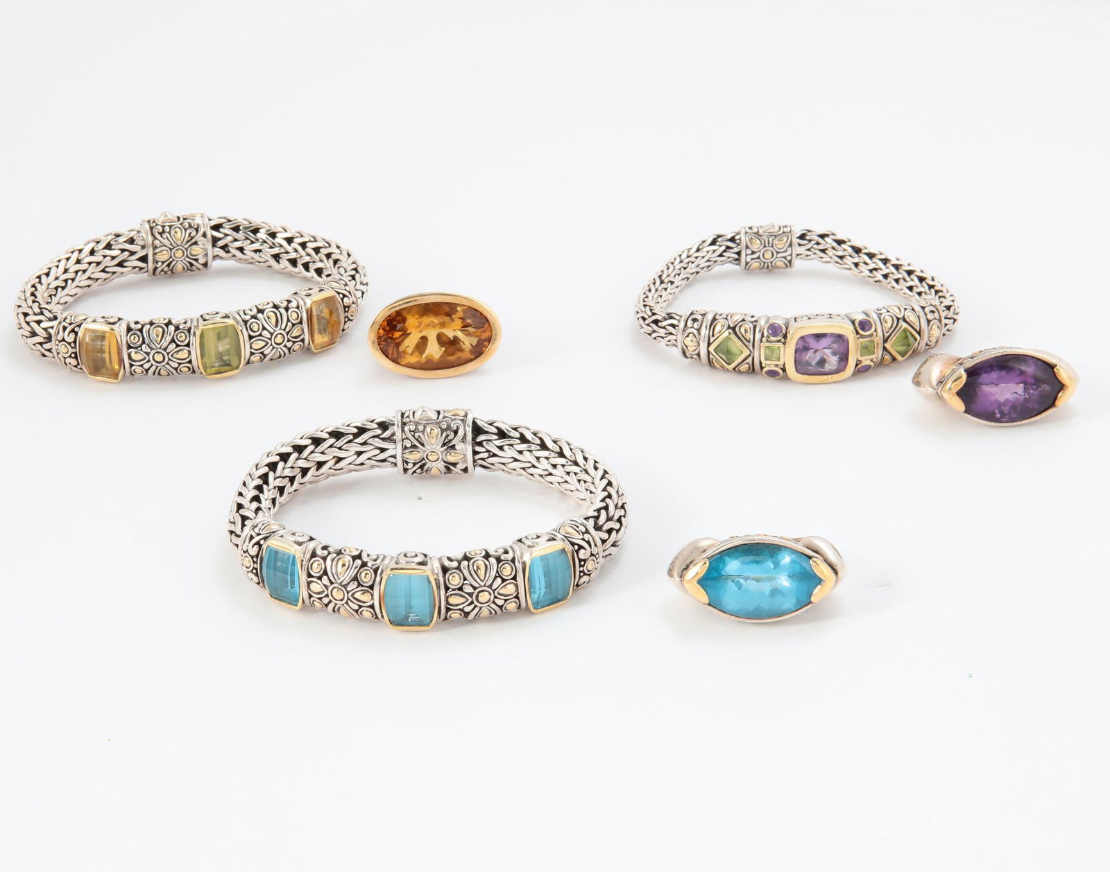 John Hardy: six pieces of gold and gemstone jewelry: John Hardy: a six piece collection of gemstone, 18K gold and sterling silver jewelryFeaturing three bracelets and three rings of similar gemstones: amethyst, peridot, blue topaz and citrine, sizes 5,