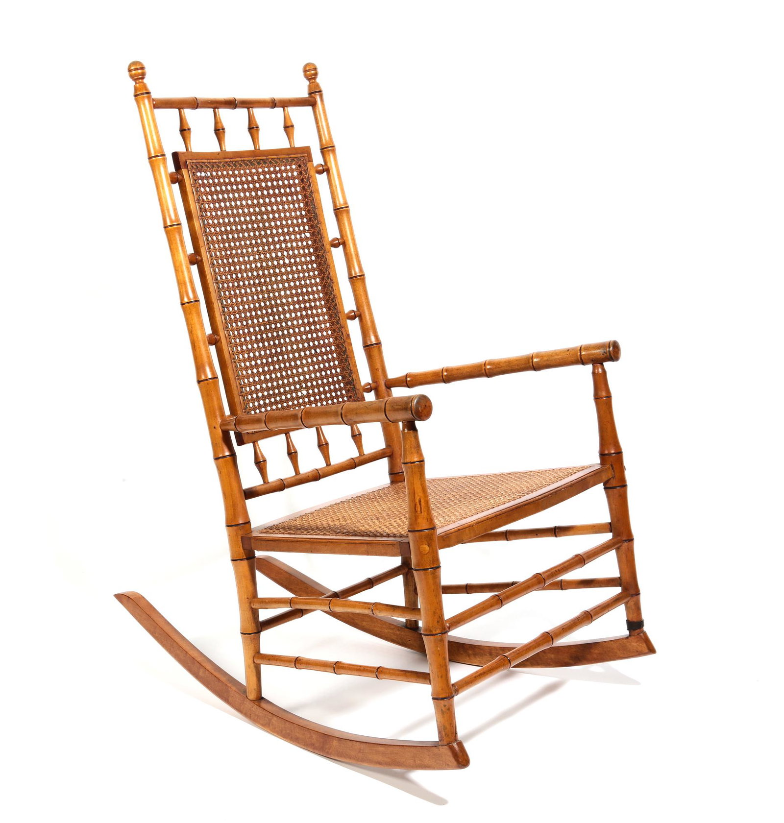 A faux bamboo and cane paneled rocking chair: A faux bamboo and cane paneled rocking chair 20th century height 42 1/4in (107cm); width 22 1/2in (57cm); depth of seat 18in (45.5cm) Provenance: Property from a Private Washington D.C. and Connecticu