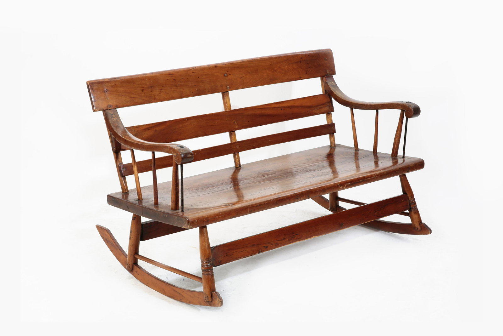 An American mixed wood slat back rocking bench: An American mixed wood slat back rocking bench 19th century height 29 1/2in (75cm); width 51in (129.5cm); depth of seat 18 1/2 (47cm) Provenance: Property from a Private Washington D.C. and Connecticu