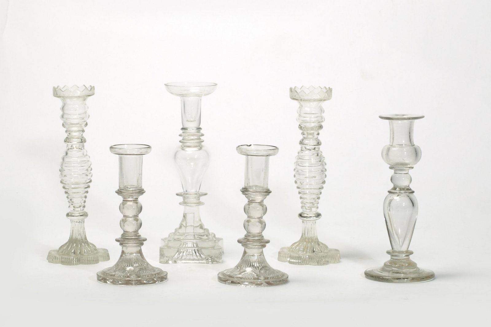 Six American flint glass candlesticks: A group of six American free-blown and pressed colorless flint glass candlesticks some possibly Mid-Western, Boston & Sandwich Glass Company, and Pittsburgh area mid 19th century Comprising two pairs 