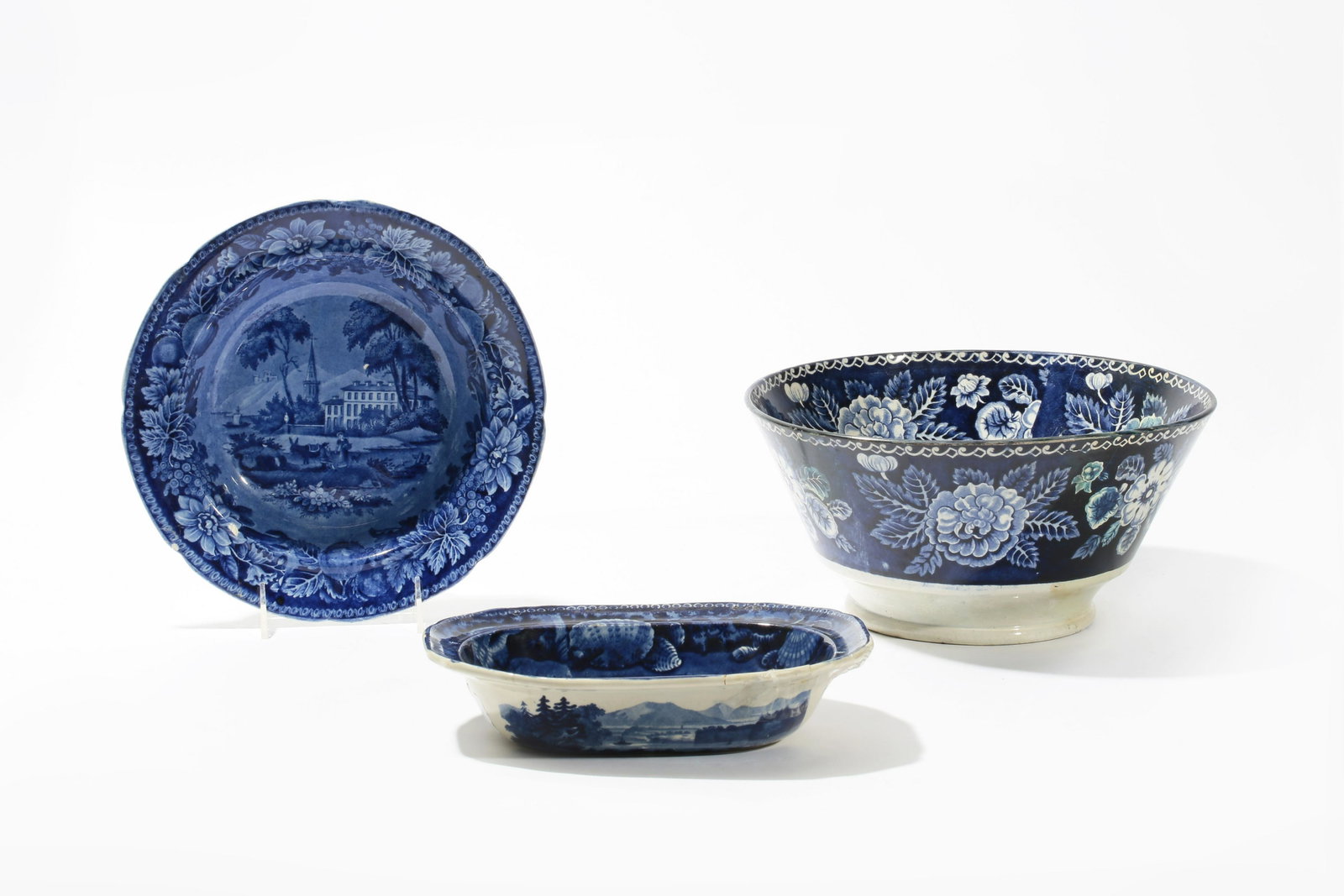 Three Staffordshire historical table wares: Three Staffordshire historical blue transfer decorated earthenware table wares first half 19th century Comprising a large punch bowl depicting the "Capitol Washington", a 10in soup plate dep
