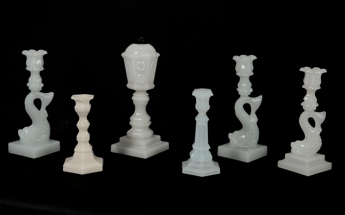 Five American flint glass candlesticks: A group of five American pressed clambroth flint glass candlesticks probably Boston & Sandwich Glass Company 19th century Together with a clambroth pressed whale oil / fluid stand lamp. (6) heights ra