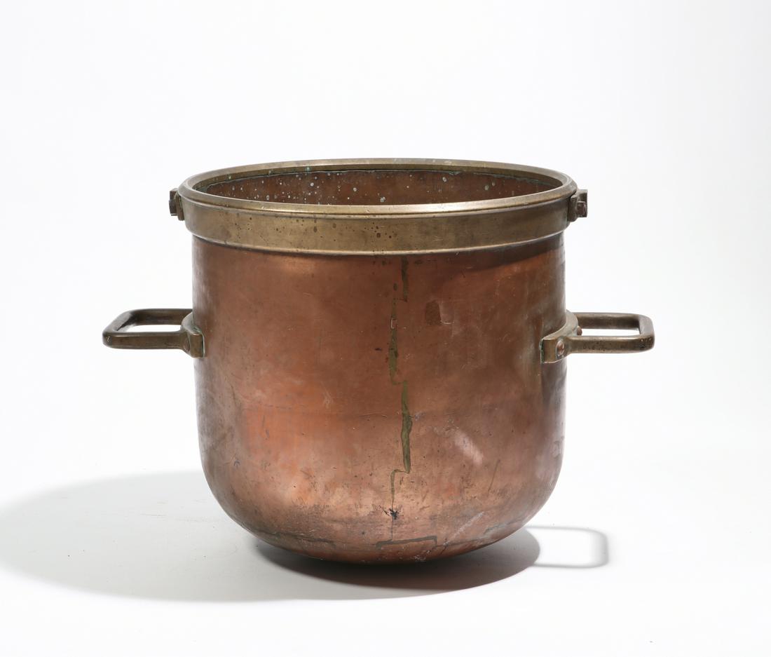 A large brass mounted copper pot: A large brass mounted copper pot early 20th century height 19in (48cm); width over handles 27in (68.5cm)