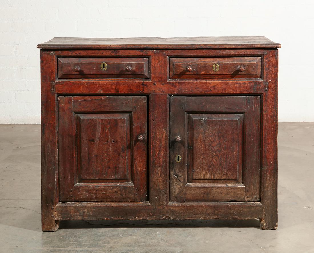 A George II oak side cabinet, North Wales: A George II oak side cabinet North Wales second quarter 18th century height 35in (89cm); width 45in (114cm); depth 21in (53.5cm) Provenance: Sold Sothebys, Olympia, 1 July 2003, lot 246. Property of a
