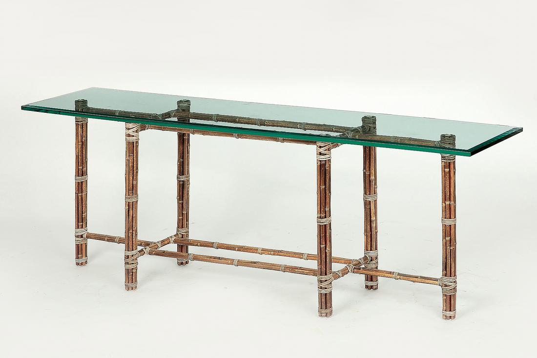 A McGuire bamboo and beveled plate glass console table: A McGuire bamboo and beveled plate glass console table height 29in (74cm); width 84in (123cm); depth 18in (46cm)