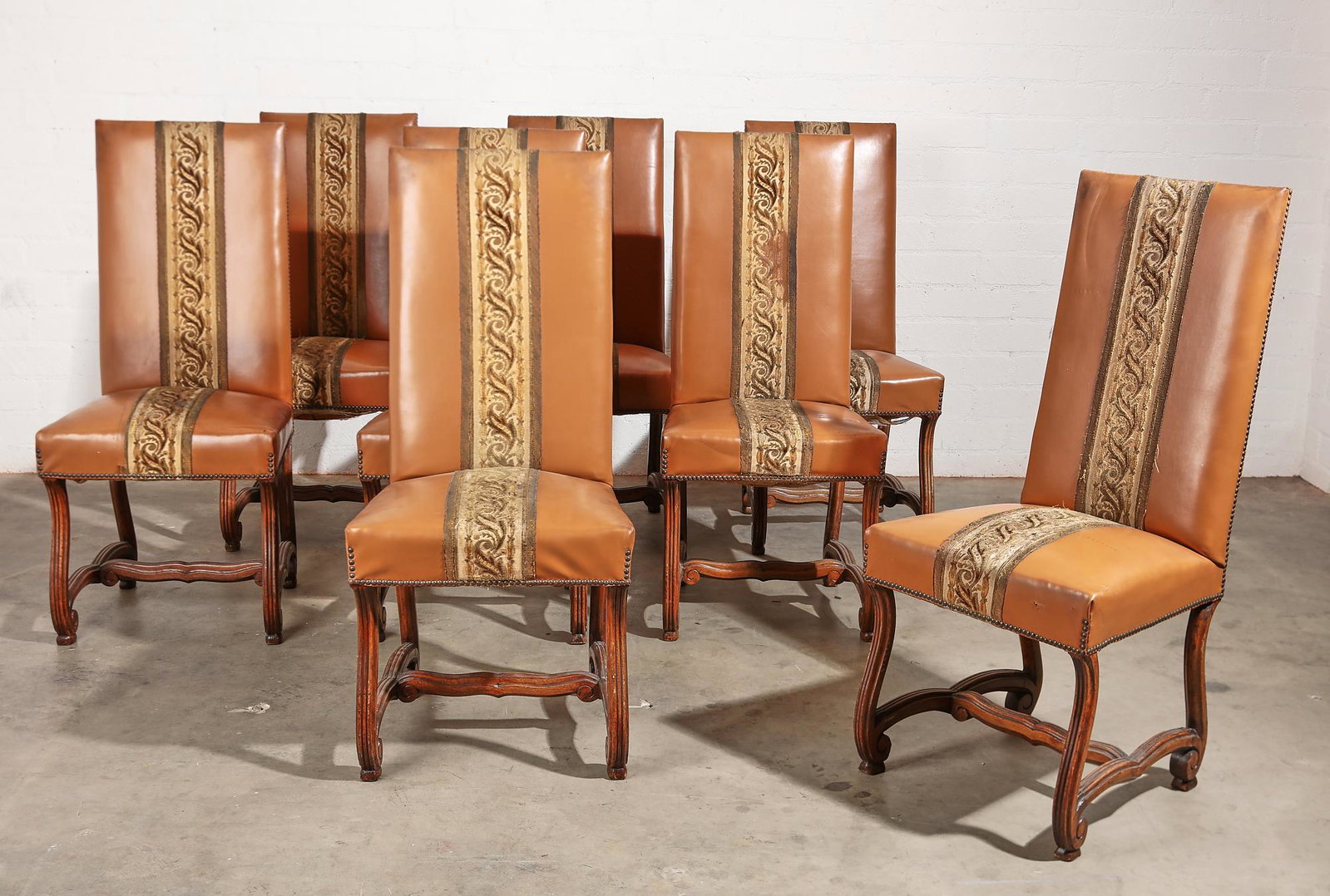 A set of eight Baroque style walnut dining chairs: A set of eight Continental Baroque style upholstered walnut dining chairs 20th century height 41 1/2in (105.5cm); width 19in (48cm); depth of seat 15in. (38cm)