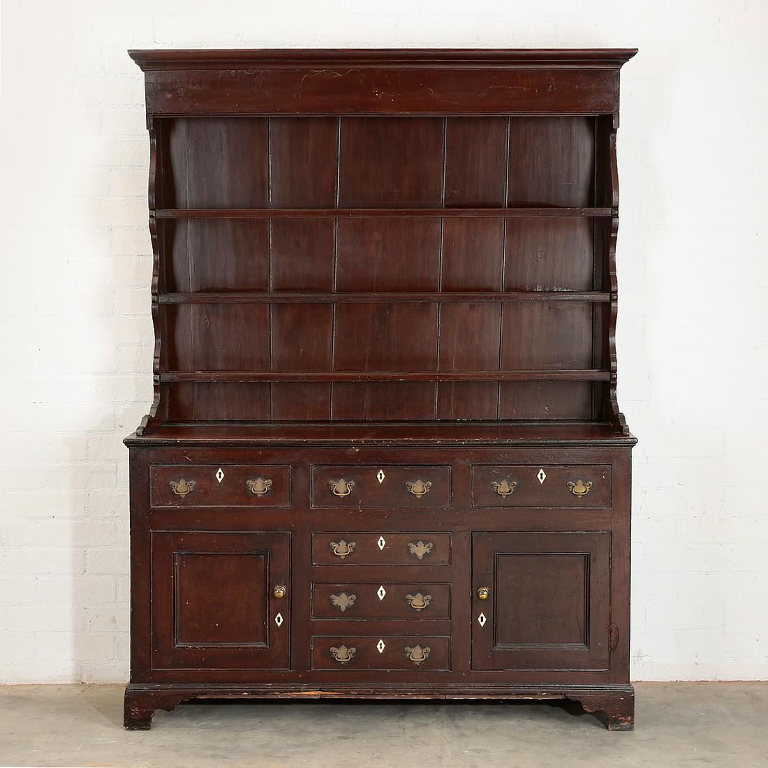A George III oak Welsh dresser: A George III oak Welsh dresser fourth quarter 18th century height 82 3/4in (210cm); width 62 1/2in (159cm); depth 17 1/2in (44.5cm) Provenance: Property from the Estate of Keith McCoy, Los Angeles, Ca