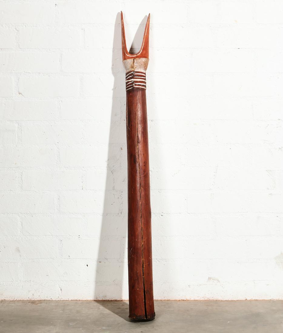 A Sepik River kundu hand drum: A Sepik River paint decorated carved wood kundu hand drumPapua, New Guinealength 48 3/4in (124cm); diameter 4 1/4in (10.5cm)