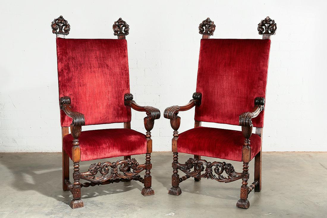 A pair of Continental Baroque style armchairs: A pair of Continental Baroque style carved walnut armchairs early 20th century height 59in (150cm); width 28 3/4in (73cm); depth of seat 16in (40.5cm)