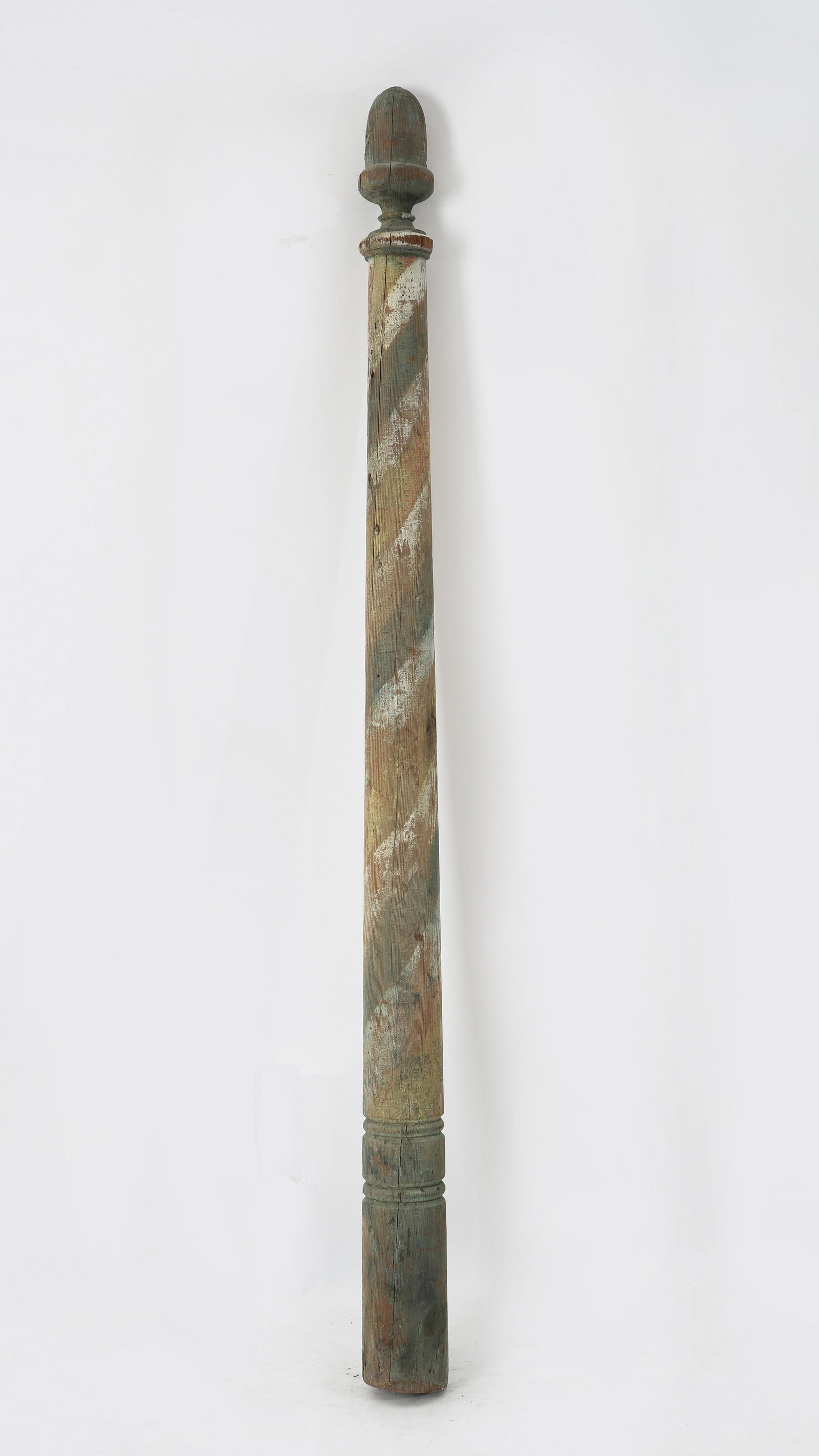 An American painted pine barber pole: An American painted pine barber pole late 19th/early 20th century Having an acorn shaped finial. height 84 1/4in (214cm); diameter at bottom 5 1/2in (14cm) Provenance: Property from a Long Beach, Cali