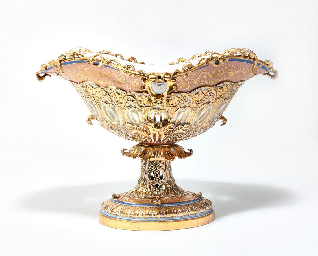 A Continental porcelain centerpiece: A Continental gilded porcelain reticulated centerpiece late 19th century height 16 1/4in (41cm); width 22 3/4in (57.5cm); depth 15 3/4in (40cm)