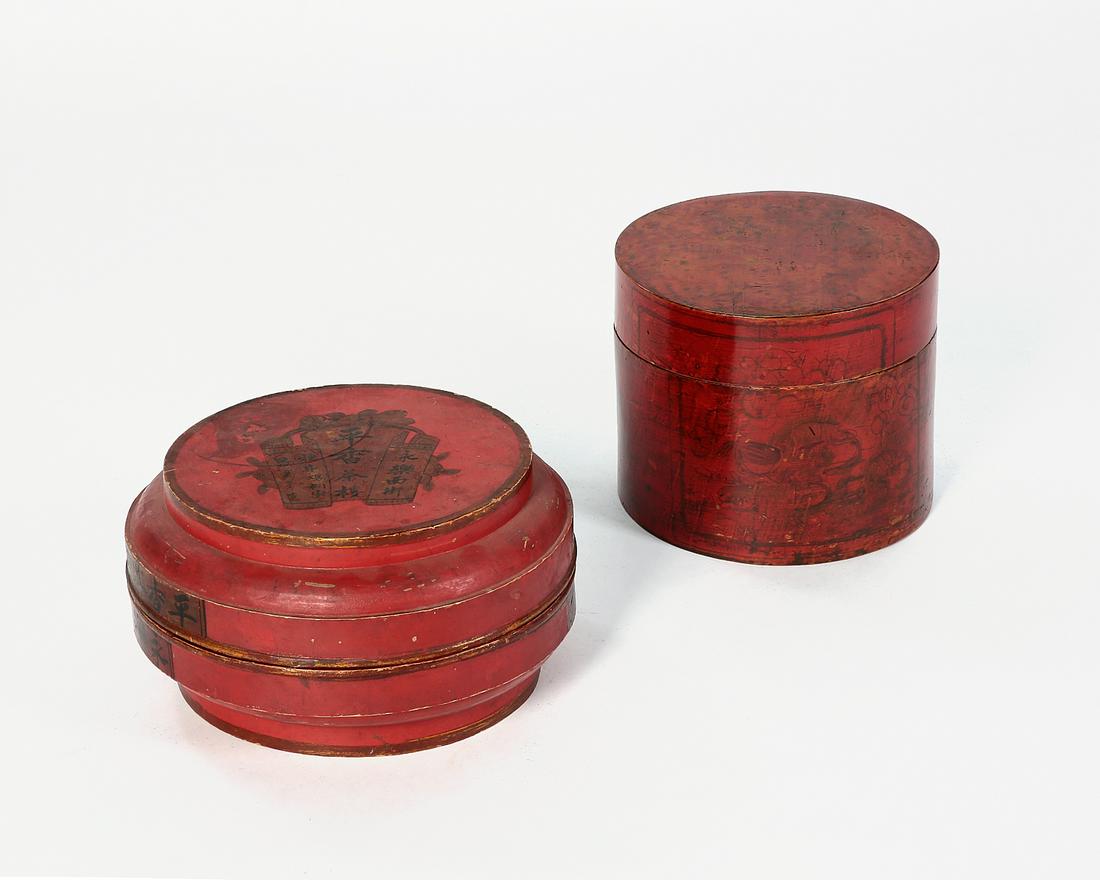 Two red painted table boxes: Two red painted table boxes height of taller 10 1/4in (26cm); diameter of wider 14 1/2in (37cm) Provenance: Property from the Estate of Keith McCoy, Los Angeles, California.