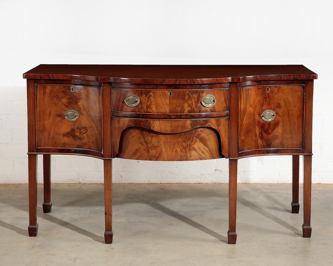 A George III style mahogany serpentine sideboard: A George III style mahogany serpentine sideboard late 19th/early 20th century height 35 1/2in (90cm); width 60in (152.5cm); depth 26in (66cm) Provenance: Property from the Estate of Keith McCoy, Los A