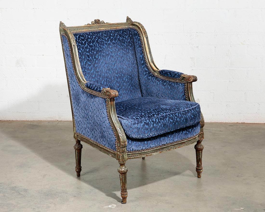 A Louis XVI style grey painted bergere: A Louis XVI style parcel gilt and grey painted bergere 20th century height 39in (99cm); width 26 1/2in (67.25cm) 20 1/2in (52cm)
