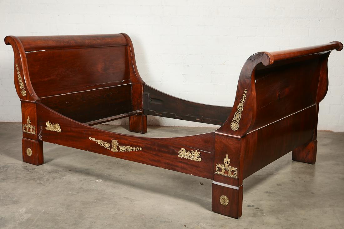 An Empire style mahogany sleigh bed: An Empire style gilt bronze mounted mahogany sleigh bed 19th century height 39 1/2in; width 53in; length 88in; interior dimensions 71 1/2 x 51in Provenance: Property from the Estate of Keith McCoy, Lo