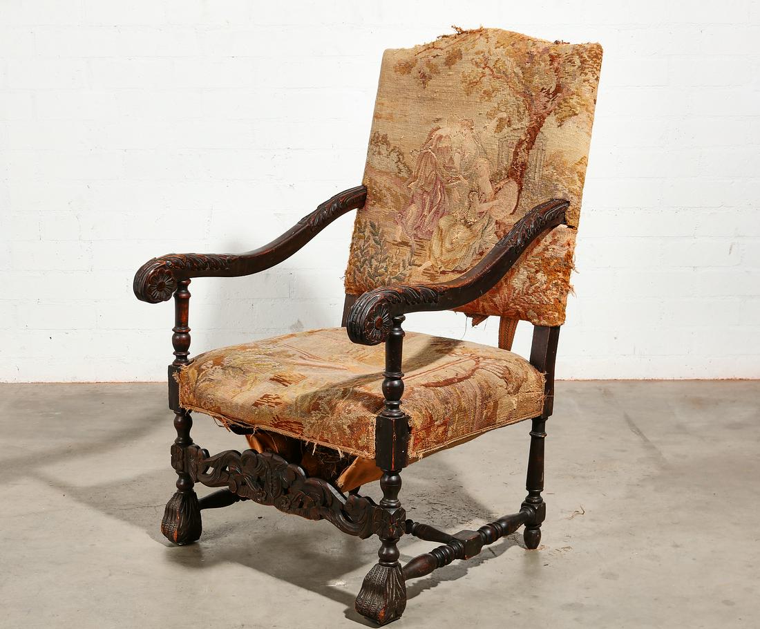 A Continental Baroque style armchair: A Continental Baroque style carved beechwood armchair late 19th century Having a needlework upholstered seat and back. height 44in (111.5cm); width 26in (66cm); depth of seat 21in (53.5cm) Provenance: