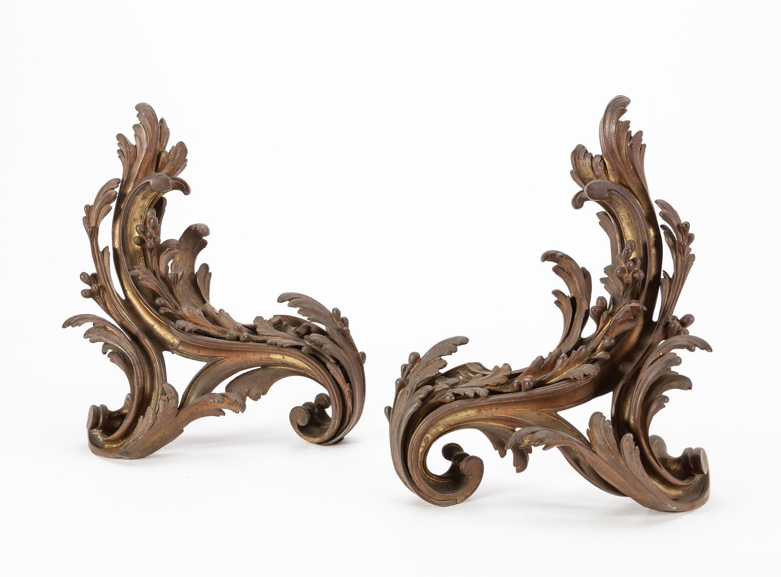 A pair of Louis XV style gilt bronze chenets: A pair of Louis XV style gilt bronze chenets late 19th century height 17in (43cm); width 12in (30.5cm); depth 6in (15cm)