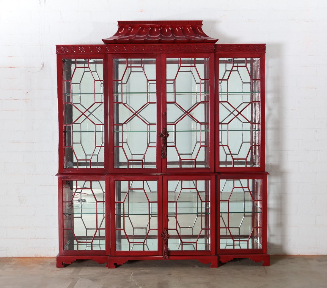 A Chinese Chippendale style breakfront bookcase: A Chinese Chippendale style red lacquered breakfront bookcase post 1950 height 84in (214cm); width 71 1/2in (181.5cm); depth 16in (40.5cm) Provenance: Property from the Estate of June Ebensteiner, Wes