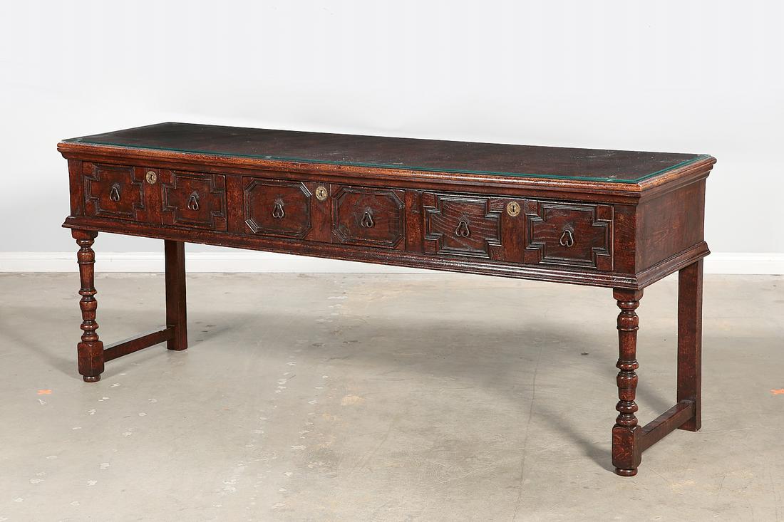 A William and Mary style oak dresser base: A William and Mary style stained oak dresser base post 1950 With glass top. height 32in (81.5cm); width 79in (200.5cm); depth 20in (51cm) Provenance: Property from the Estate of June Ebensteiner, West
