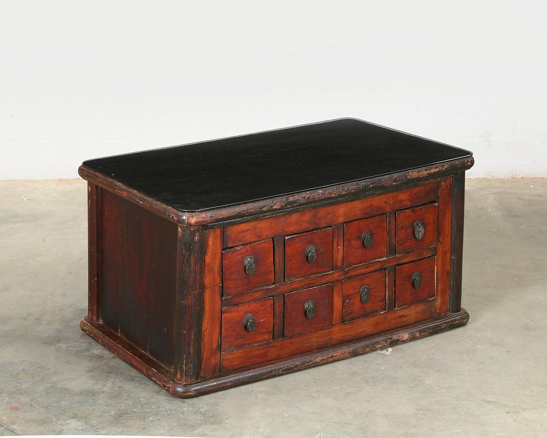 A Chinese stained low apothecary chest: A Chinese stained low apothecary chest Surmounted by a piece of tinted glass. height 20 1/2in (52cm); width 39 1/2in (100.5cm); depth 23 1/4in (59cm)