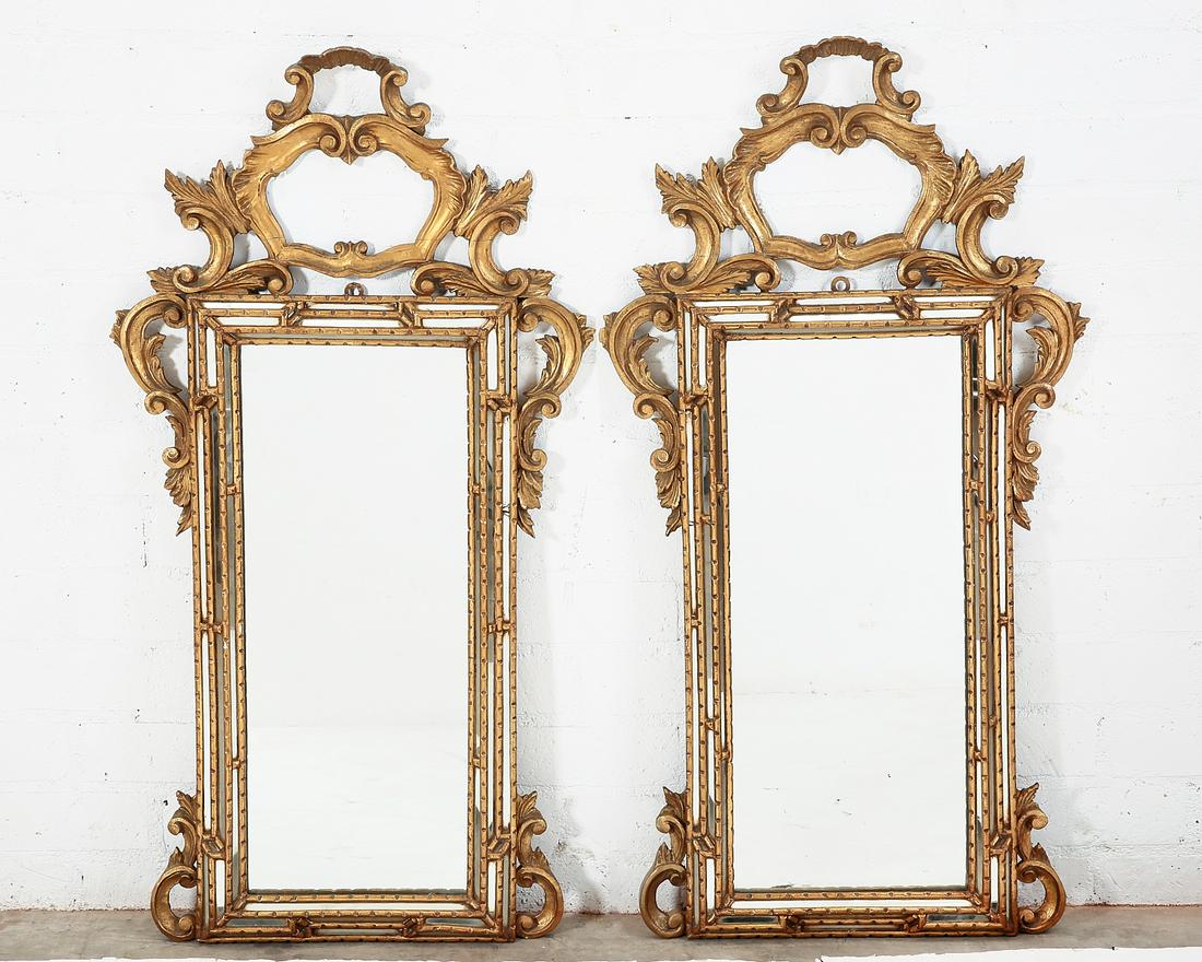 A pair of Italian Rococo style giltwood mirrors: A pair of Italian Rococo style carved giltwood mirrors 20th century height 46 1/4in (117cm); width 24in (61cm); depth 2 1/2in (6.5cm)