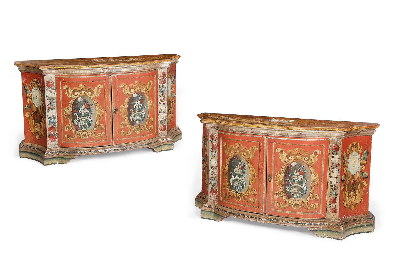 A pair of Italian Baroque style painted credenzas: A pair of Italian Baroque style polychrome decorated credenzascomposed of antique and later elementsEach with D-form top over a pair of doors enclosing a shelf.height 32 1/2in (82.5cm); width 58in (14