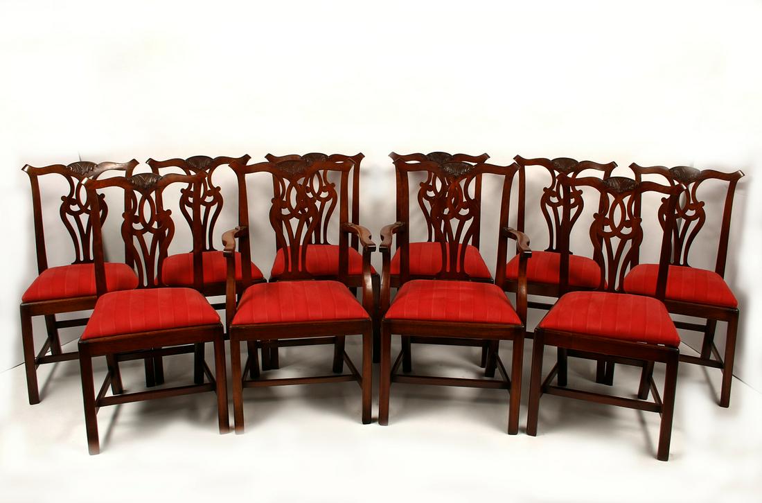 Ten George III style mahogany dining chairs: A set of ten George III style carved mahogany dining chairs 20th century Comprising a pair of armchairs and eight side chairs with slip in seats. height of armchair 39 1/2in (99cm); width 24 1/4in (62