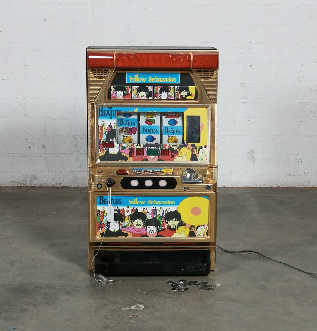 A Beatles "Yellow Submarine" slot machine: A Beatles "Yellow Submarine" fruit slot machine late 20th century height 32in (81.5cm); width 19in (48cm); depth 14in (35.5cm) Provenance: Property from a Private Collection, Bel-Air, Califo