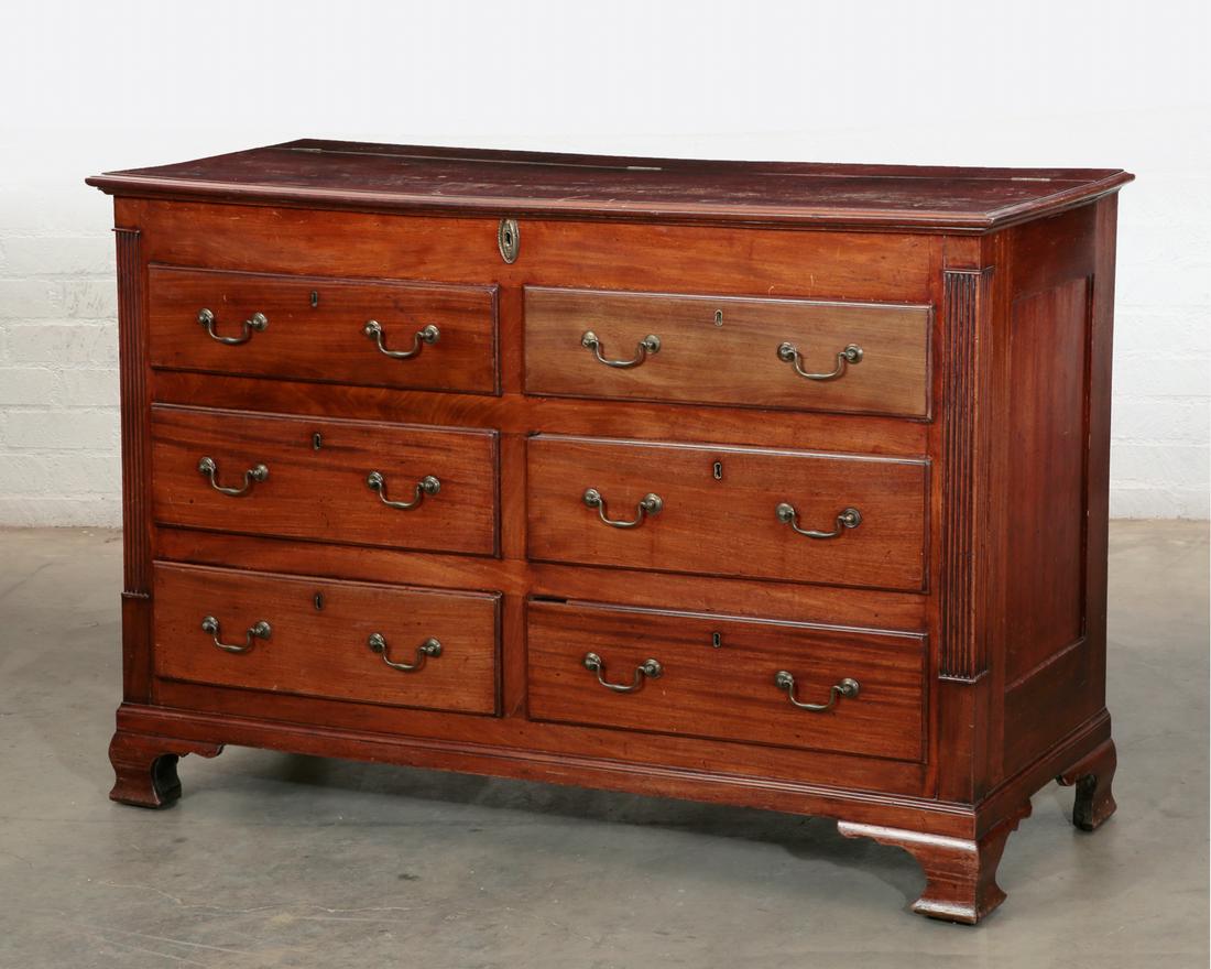 A George III mahogany mule chest, 18th century: A George III mahogany mule chest fourth quarter 18th century Having a hinged top enclosing a full width and depth compartment above six short drawers flanked by reeded pilasters on ogee bracket feet. 