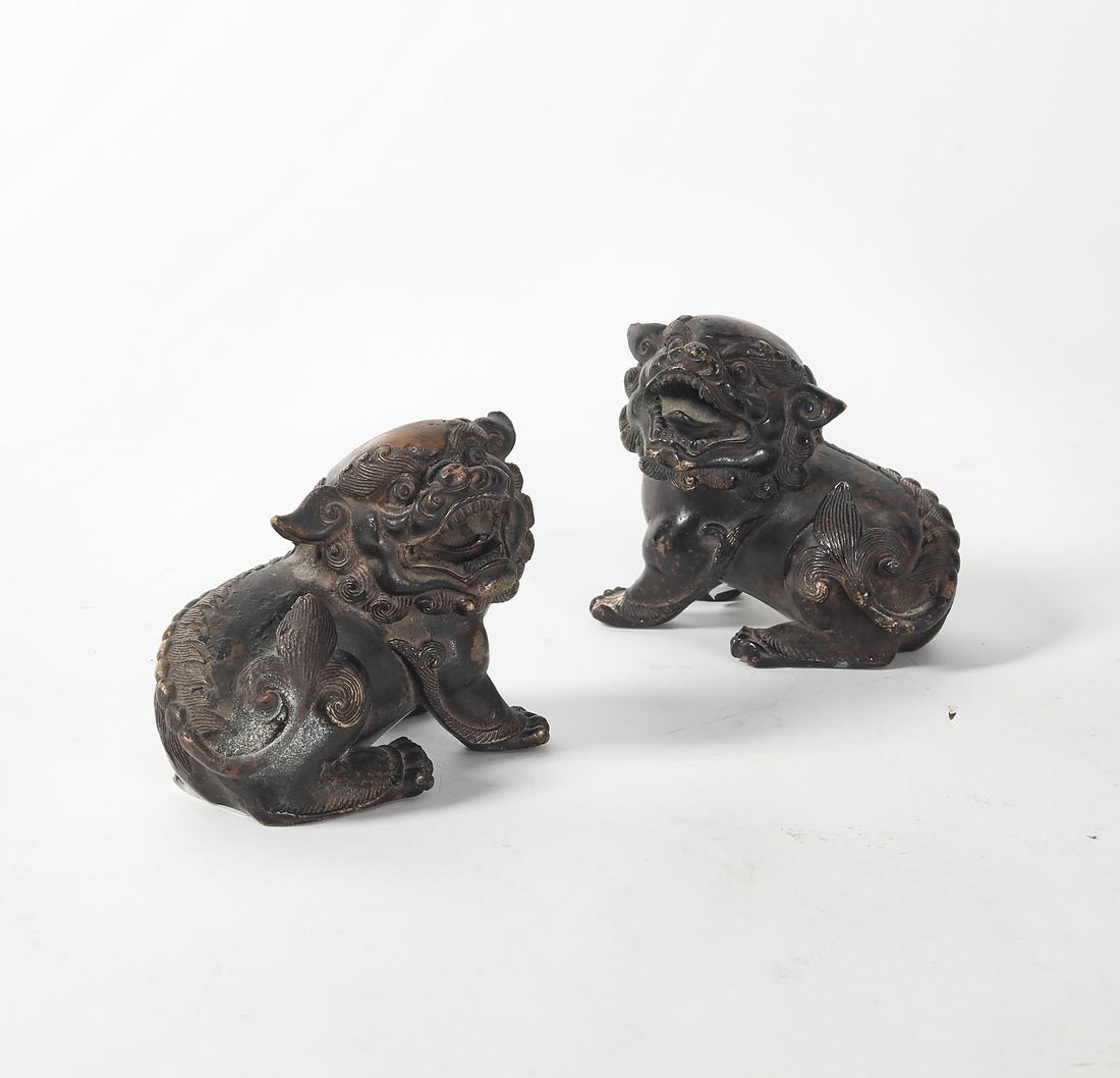 A pair of Asian patinated bronze models of temple lions (1 of 2)