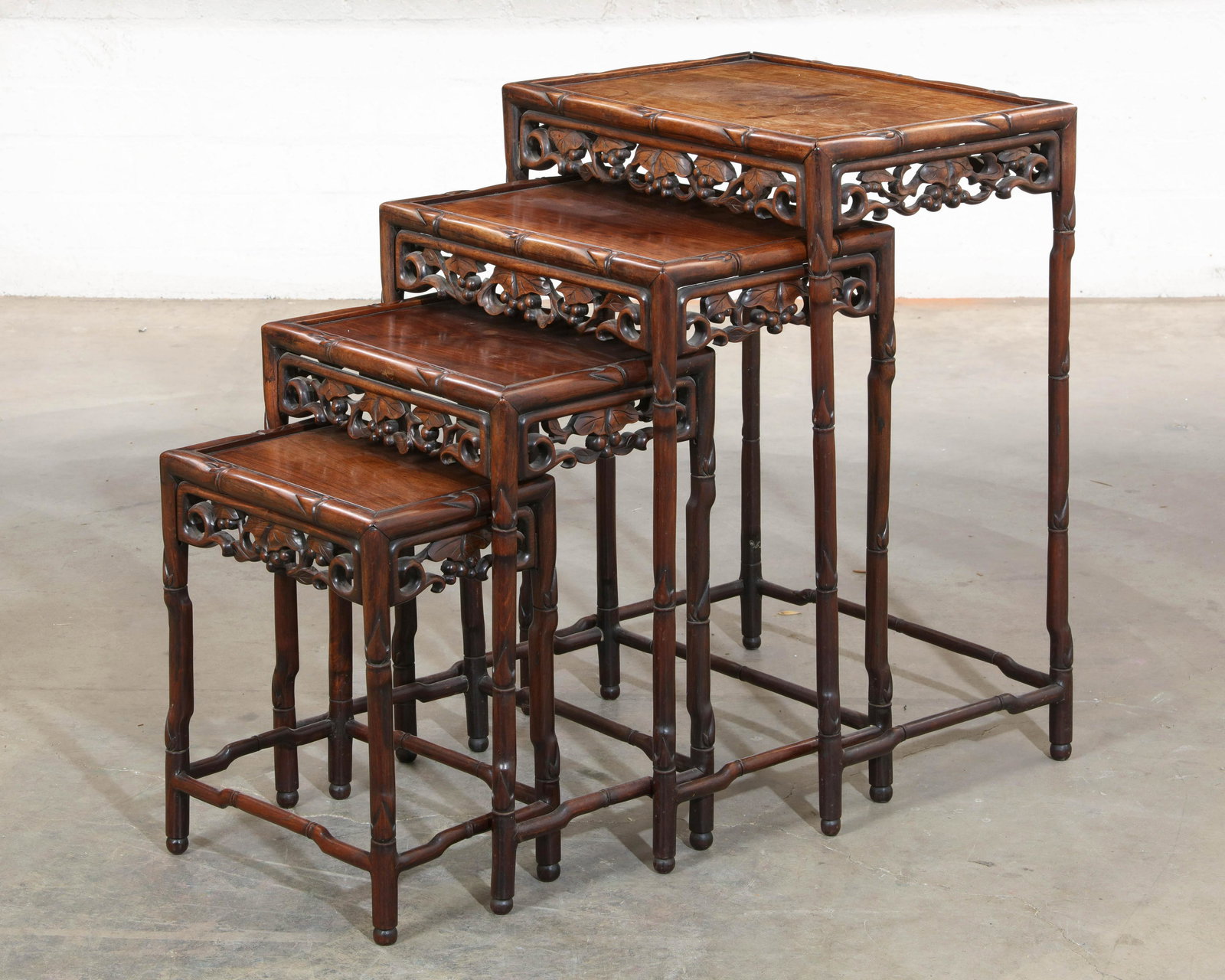 A nest of four Chinese hardwood tables: A nest of four Chinese hardwood tables the largest height 28 1/2in (72cm); width 20in (51cm); depth 14 1/2in (37cm) Provenance: Property from the Estate of Keith McCoy, Los Angeles, California.