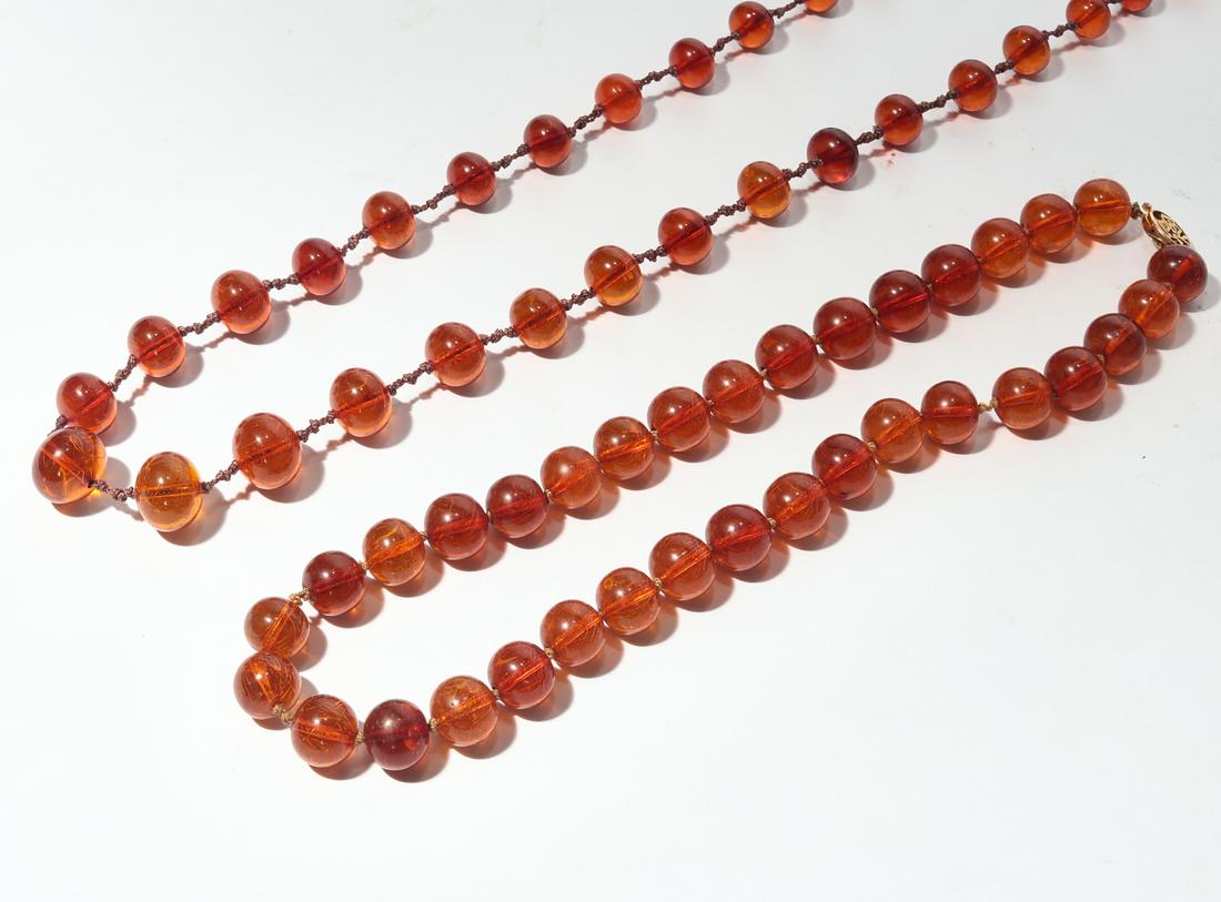 Two Chinese amber beads, with 14k gold clasps (1 of 2)