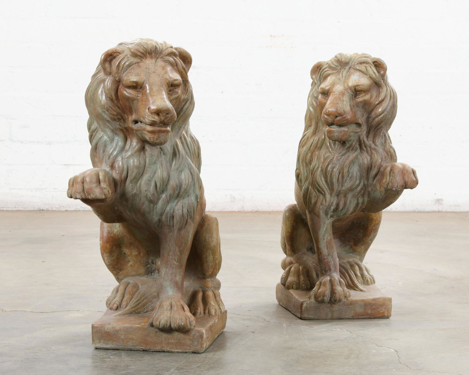 A pair of tinted stone seated lions, 20th century (1 of 2)