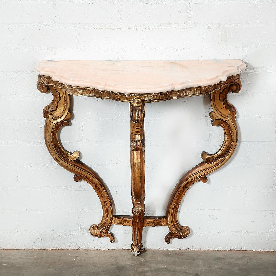 Italian Rococo style giltwood console: An Italian Rococo style giltwood console late 19th century Surmounted by a marble top. height 32 1/2in (82.5cm); width 33in (84cm); depth 19 1/2in (50cm) Provenance: Property from the Collection of Ra