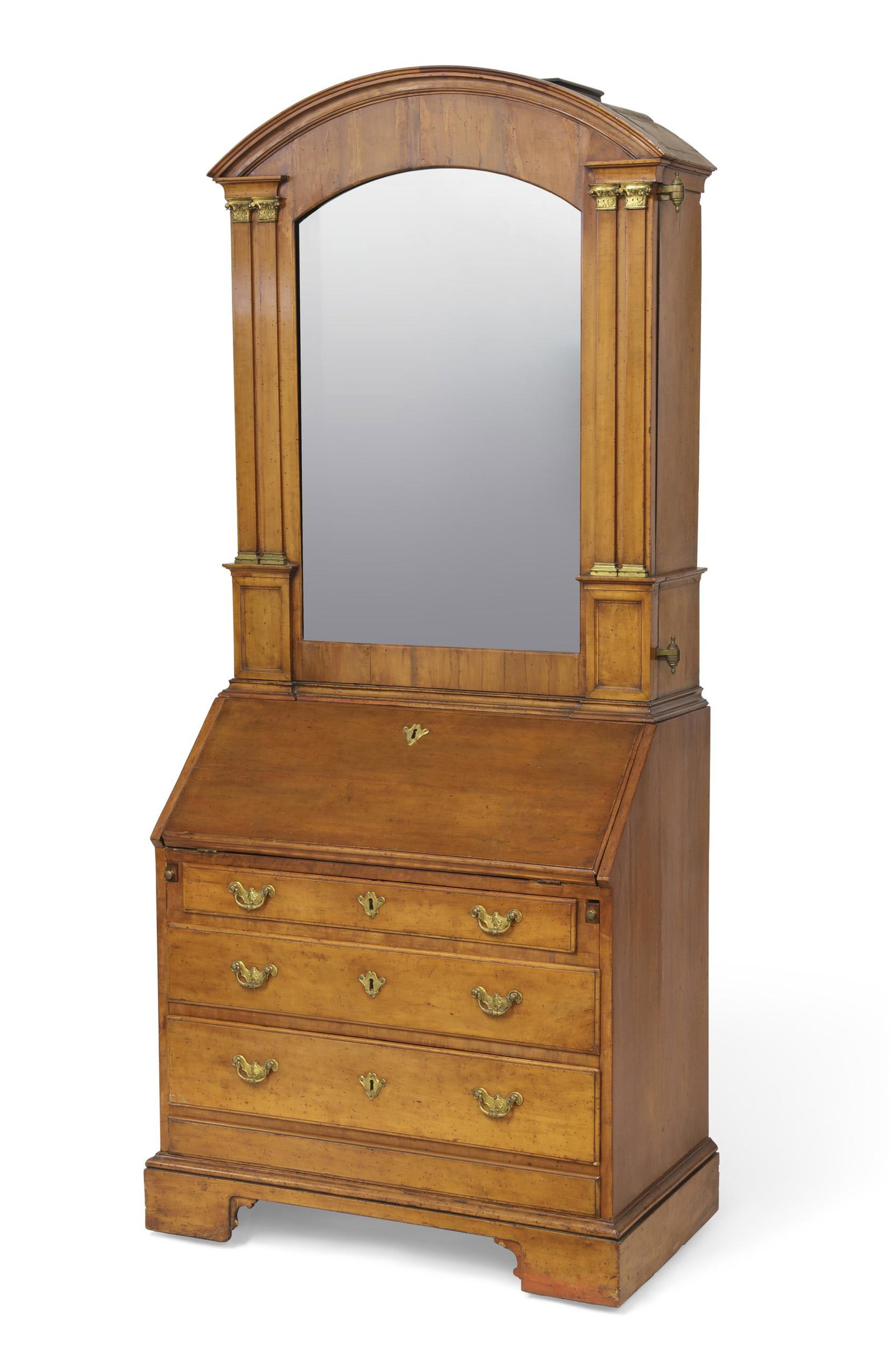 Italian fruitwood bureau cabinet: An Italian gilt bronze mounted fruitwood bureau cabinet incorporating antique and later elements The arched mirrored door enclosing a configuration of shelves and drawers centering an arch enclosing a