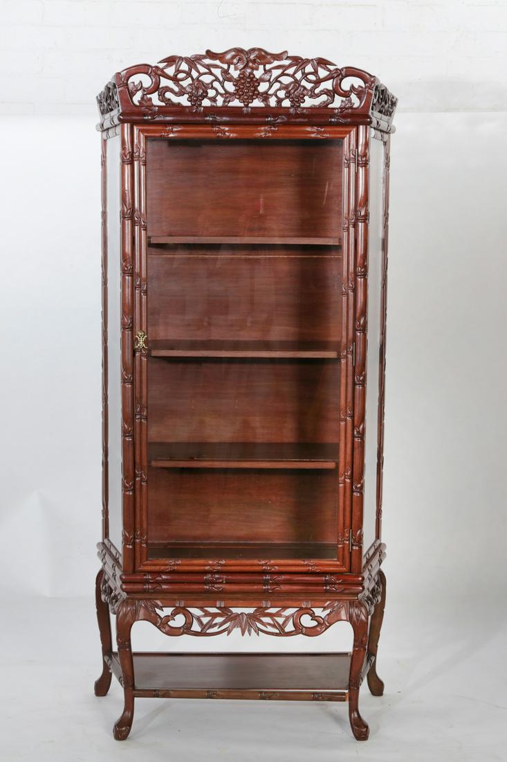 A Chinese hardwood display cabinet: A Chinese hardwood display cabinet height 77in (196cm); width 36in (91cm); depth 16 1/2in (42cm) Provenance: Property from a Private Collection, Southern California.