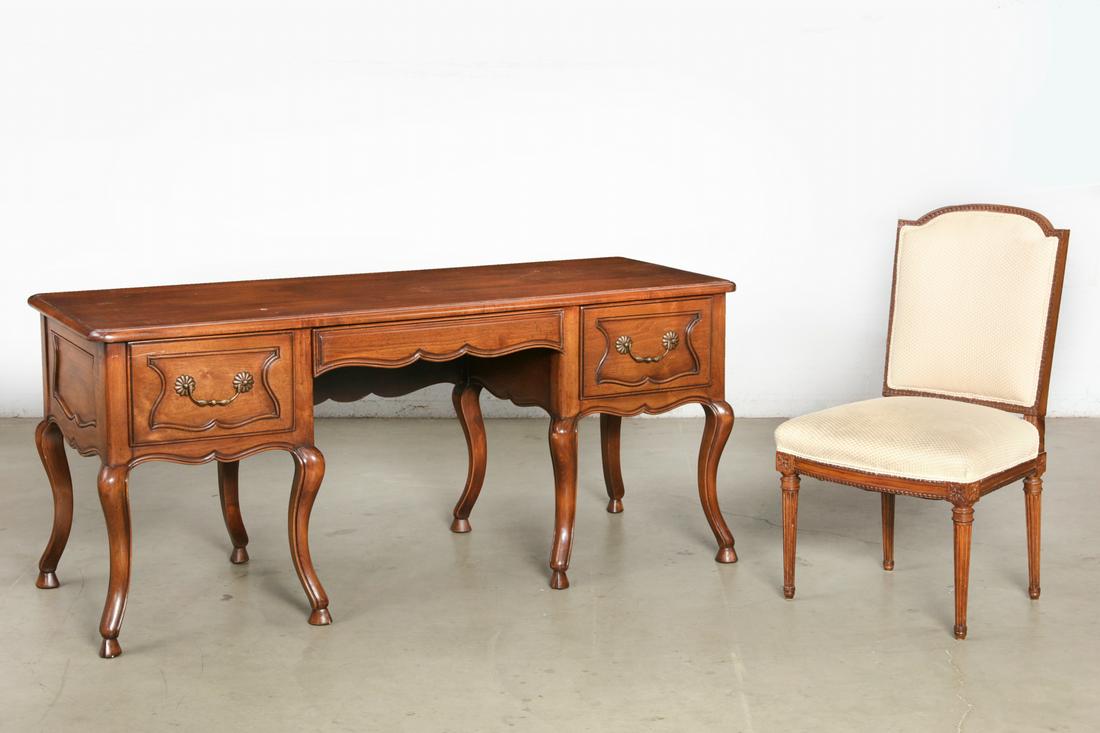 A Louis XV style stained mixed wood desk, modern: A Louis XV style stained mixed wood desk modern Together with a Louis XVI carved side chair. (2) height 30 1/2in (77.5cm); width 68 1/2in (174cm); depth 26in (66cm)