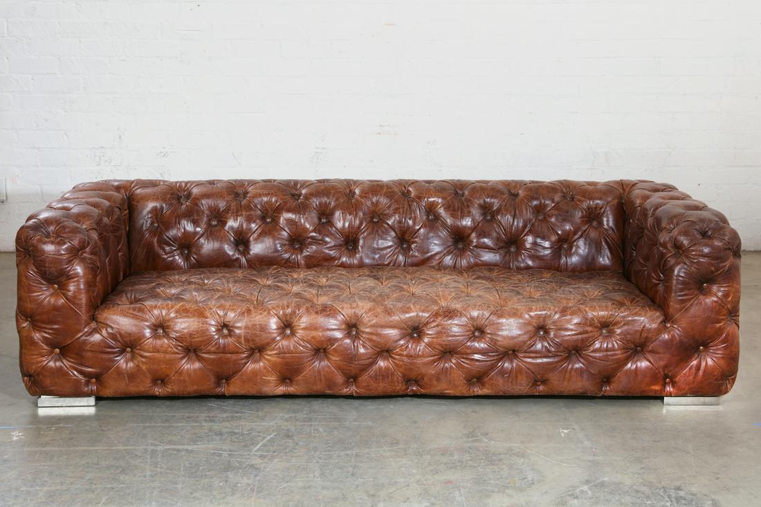 A tufted brown leather fully upholstered sofa (1 of 4)