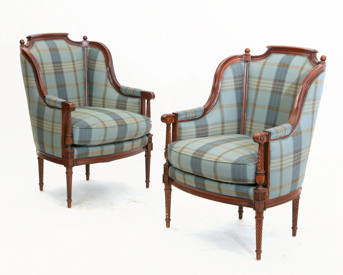 A pair of Louis XVI style mahogany bergeres: A pair of Louis XVI style carved mahogany bergeres modern height 39in (99cm); width 28 1/4in (71.5cm); depth of seat 22in (56cm) Provenance: Property from a Private Estate, Pasadena, California.