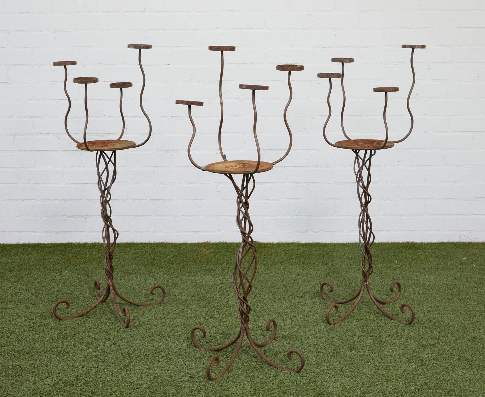 Three iron four light pedestal torcheres (1 of 2)